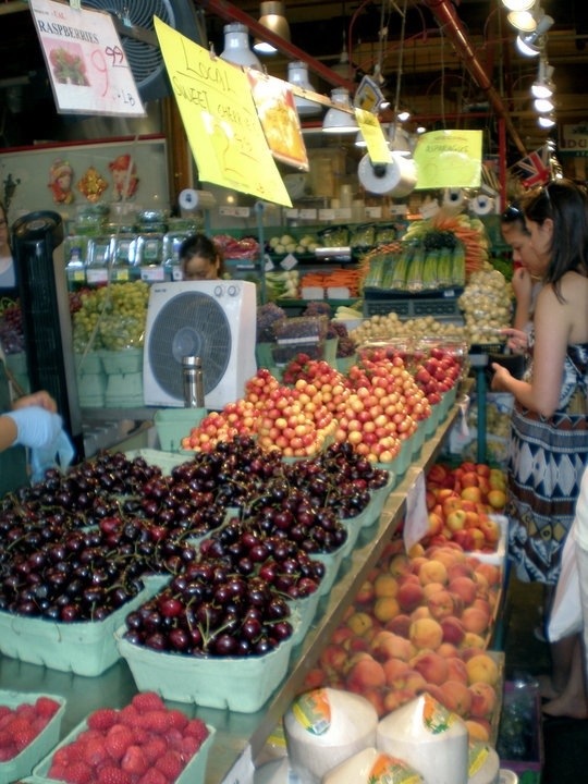 admiring the fruit at granville island public market in vancouver