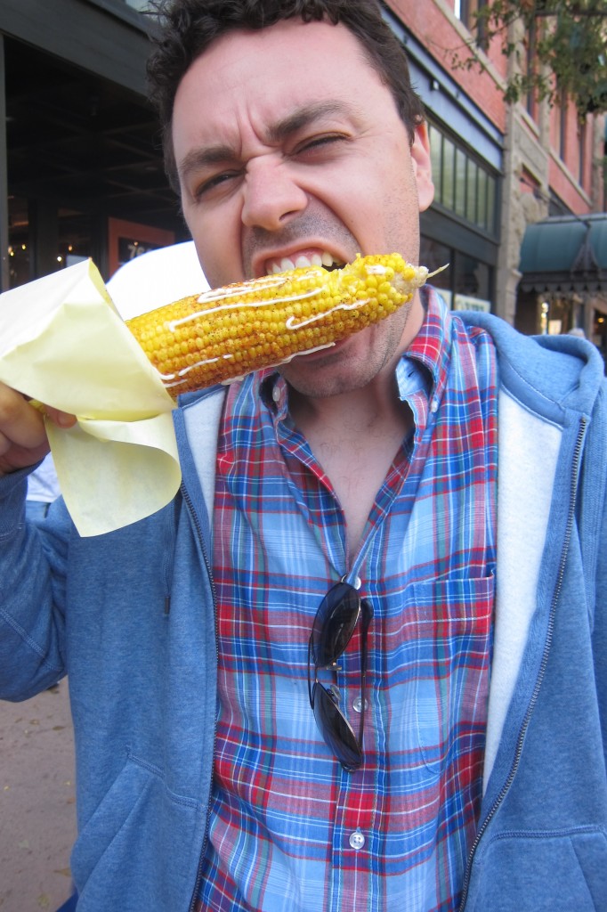 my husband eating corn from the san luis obispo thursday night farmers' market, noted on eatwellguide.org for sustainable food!