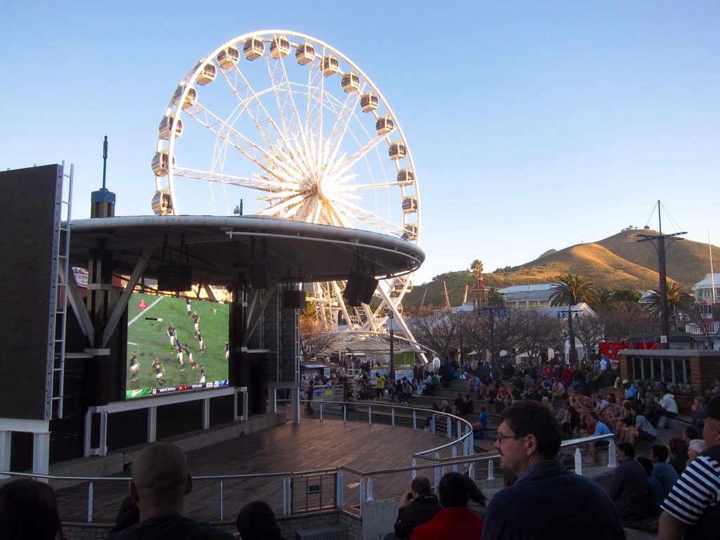 the south africa vs. scotland rugby match at the v&a waterfront in cape town. the rowdy brazil world cup game followed with a packed ampitheater.