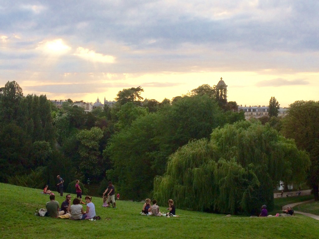 parisians picnic in the park while overlooking northeast paris